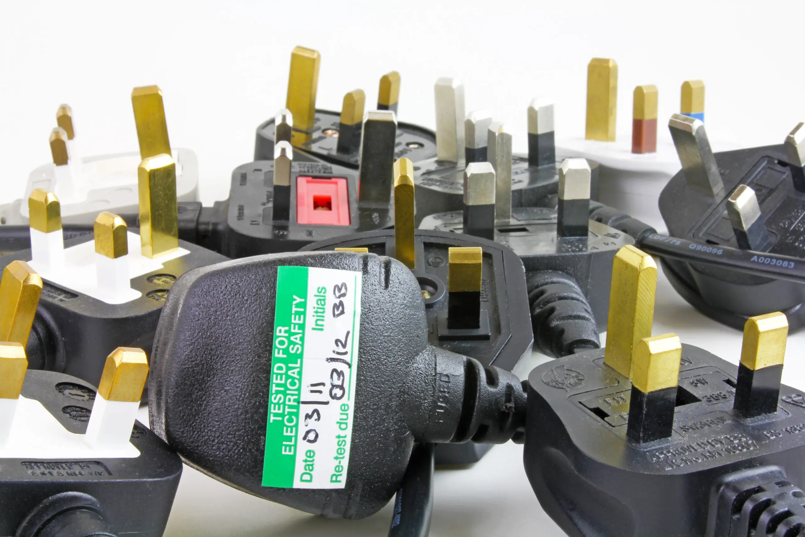 Image of plugs with a passed Pat test sticker on the back of it
