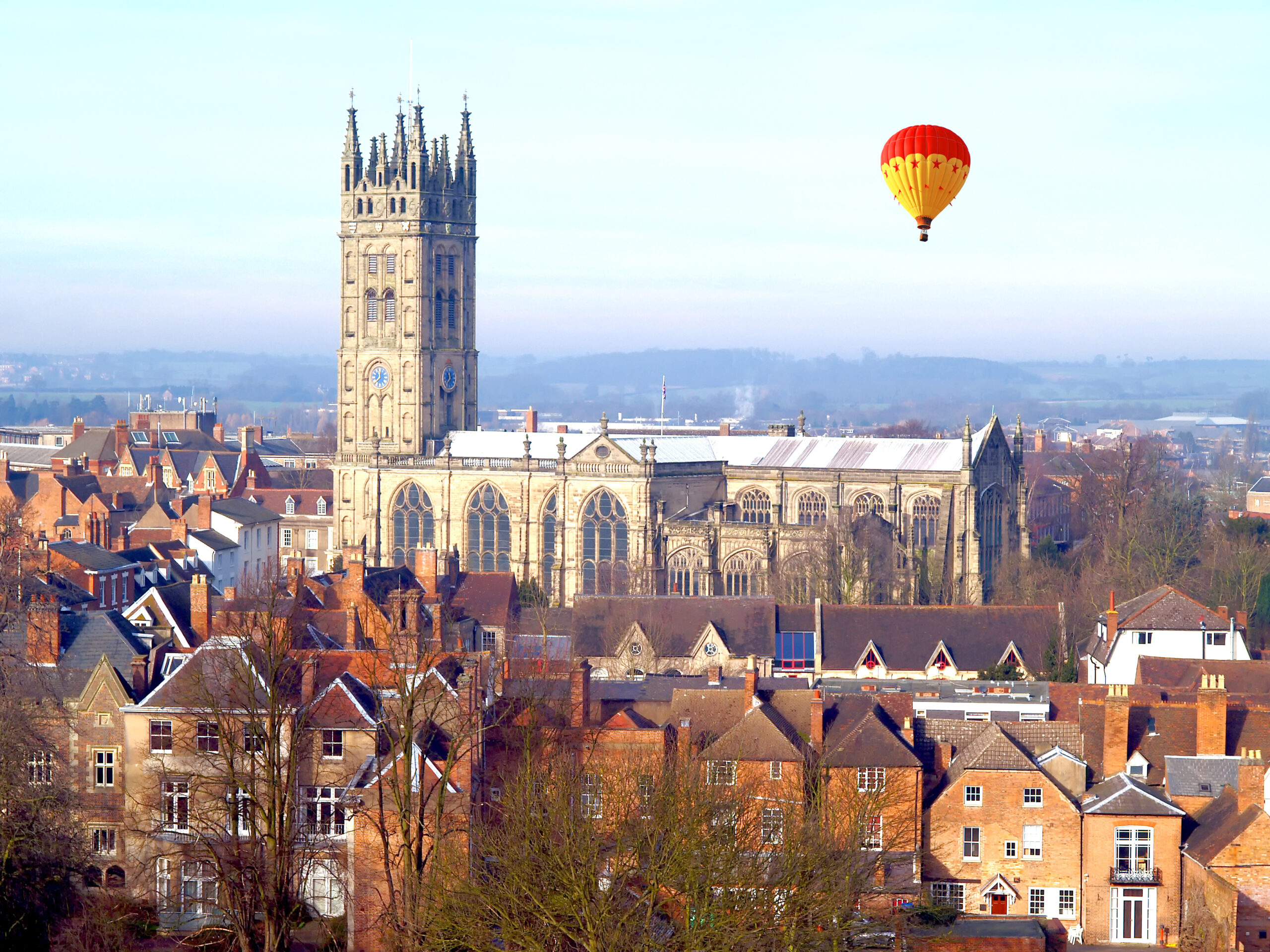 Picture of a hot air balloon over a church in Warwickshire where we provide Pat Testing