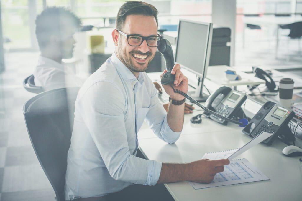 business man having conversation on Landline phone.