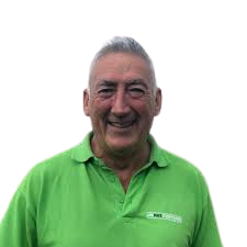 Smiling member of staff with green polo