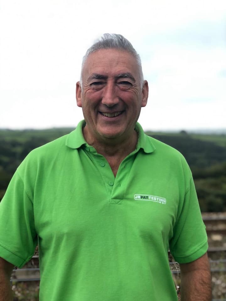 Smiling staff member wearing a bright green polo