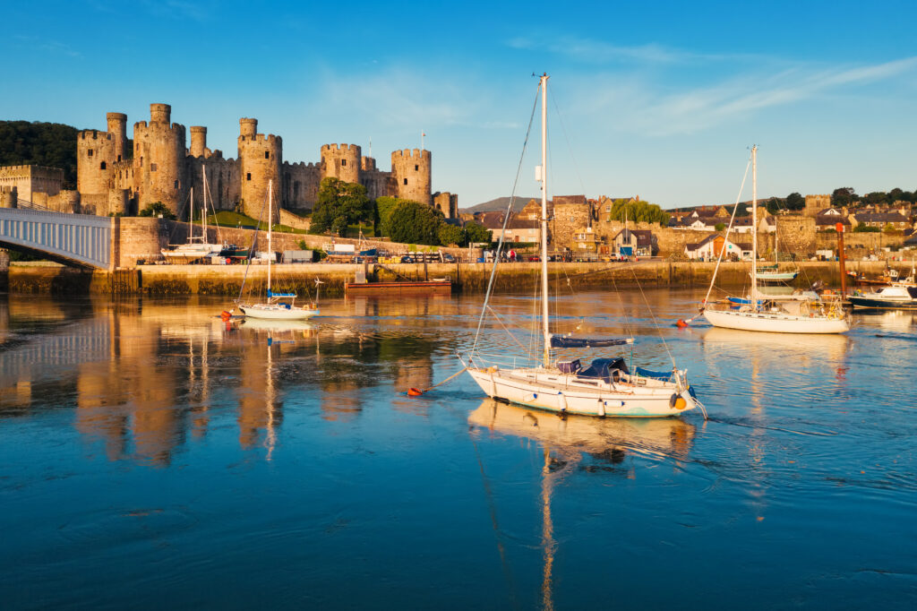 Yachts in the harbor of Conwy town in front of Conwy castle, North Wales, United Kingdom
