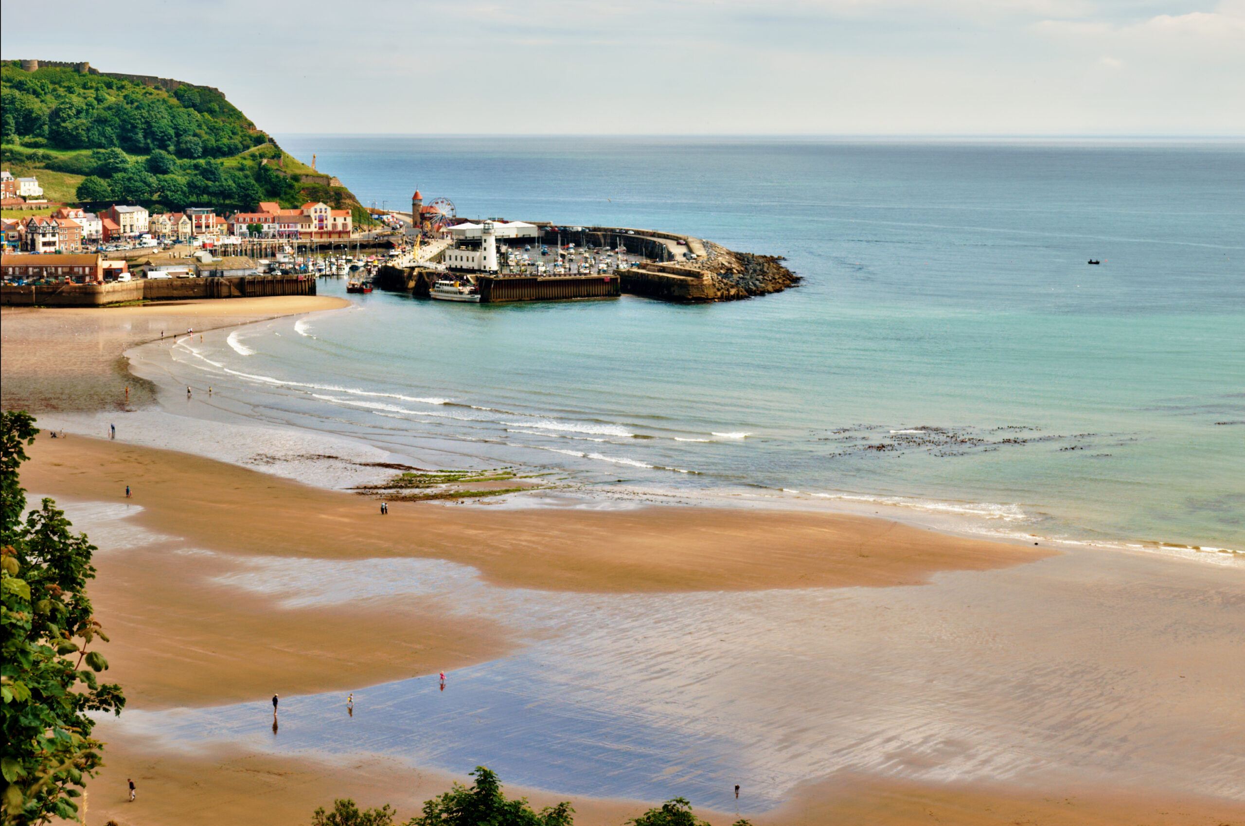 An aerial view of  the sandy beach and harbour of Scarborough, a popular holiday destination on the East coast of England