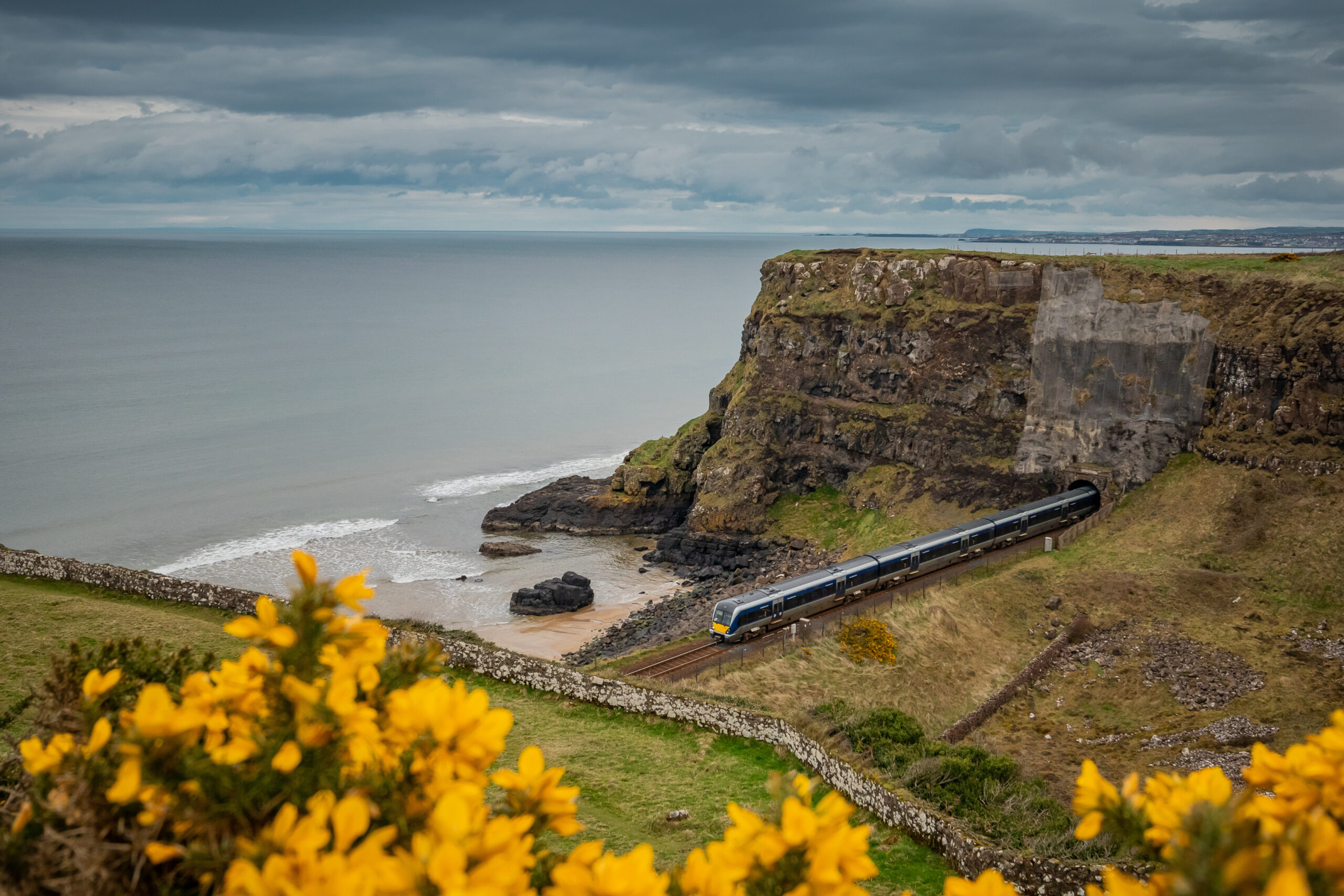 Beautiful stretch of North ireland rail between two tunnels and beach in downhill demesne close to castlerock.